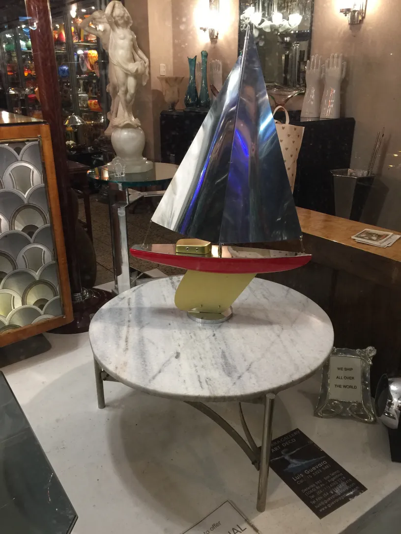 antique coffee table with sailboat design, art deco style, in an elegant setting