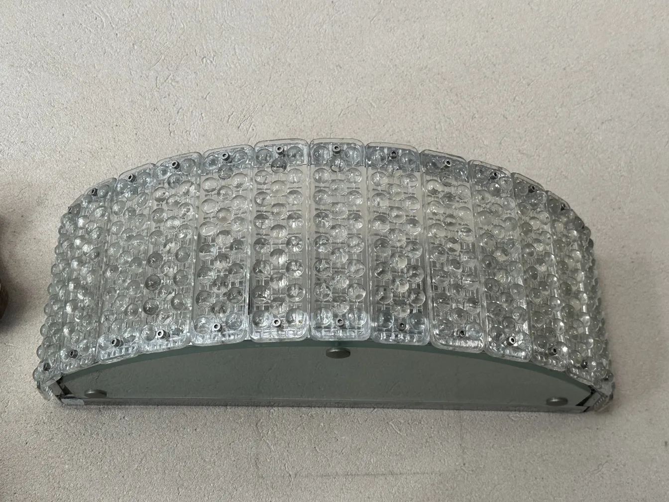 Quatro arandelas antigas dos anos 50 com um design brilhante, dispostas de forma elegante.