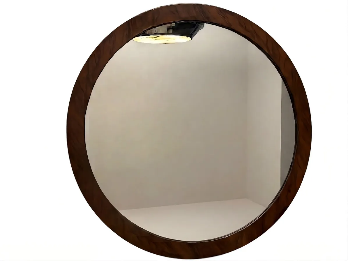 round mirror with a decorative design on the wall