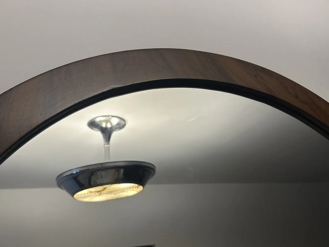 antique mirror with decorative edges reflecting light