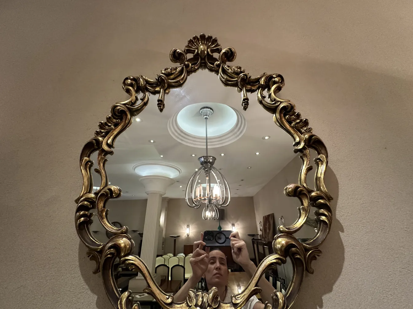 Antique decorative mirror with an ornate frame in an elegant setting