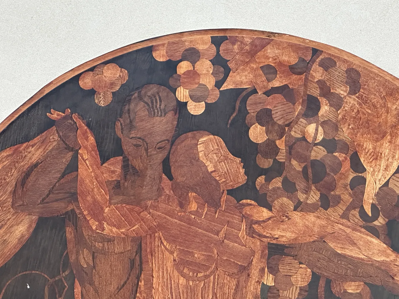 antique marquetry featuring human figures and leaves