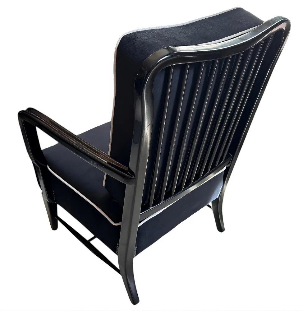 Back view of 2 elegant antique armchairs in a cozy setting