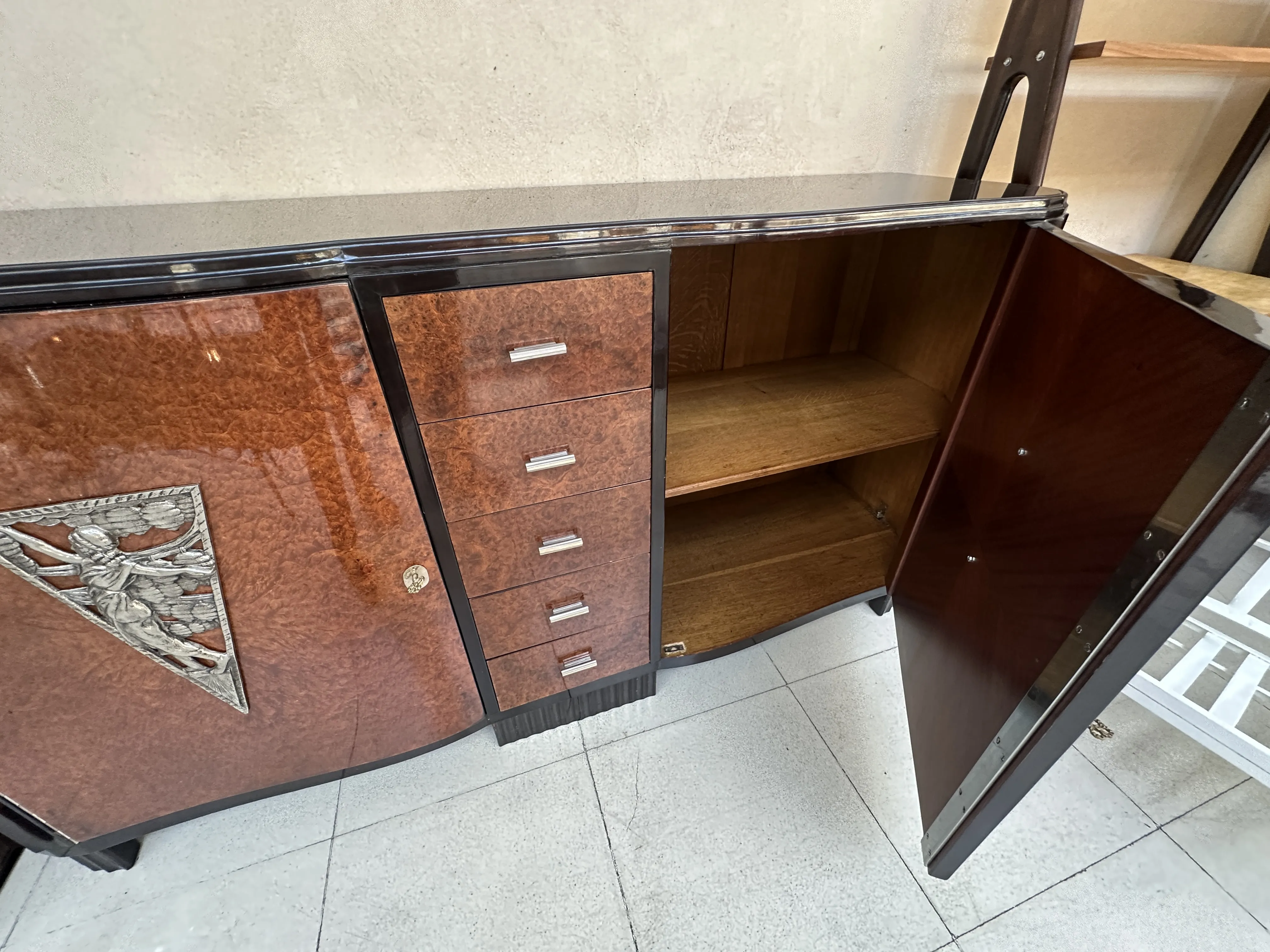 antique sideboard with decorative features and open doors, in a modern setting