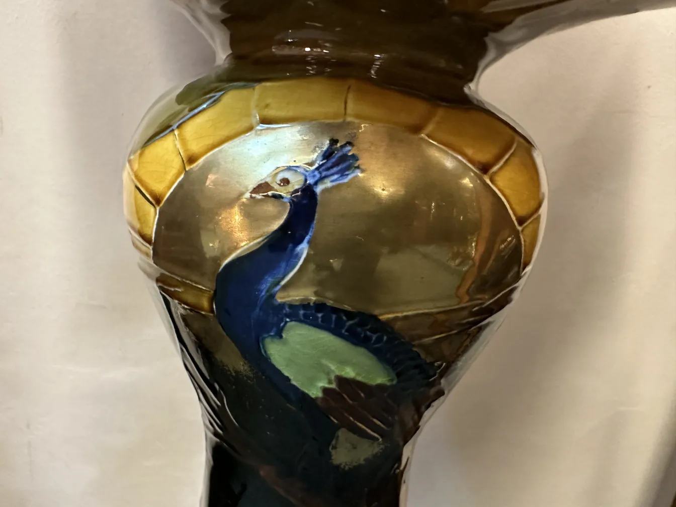 antique planter showcasing colorful peacock design