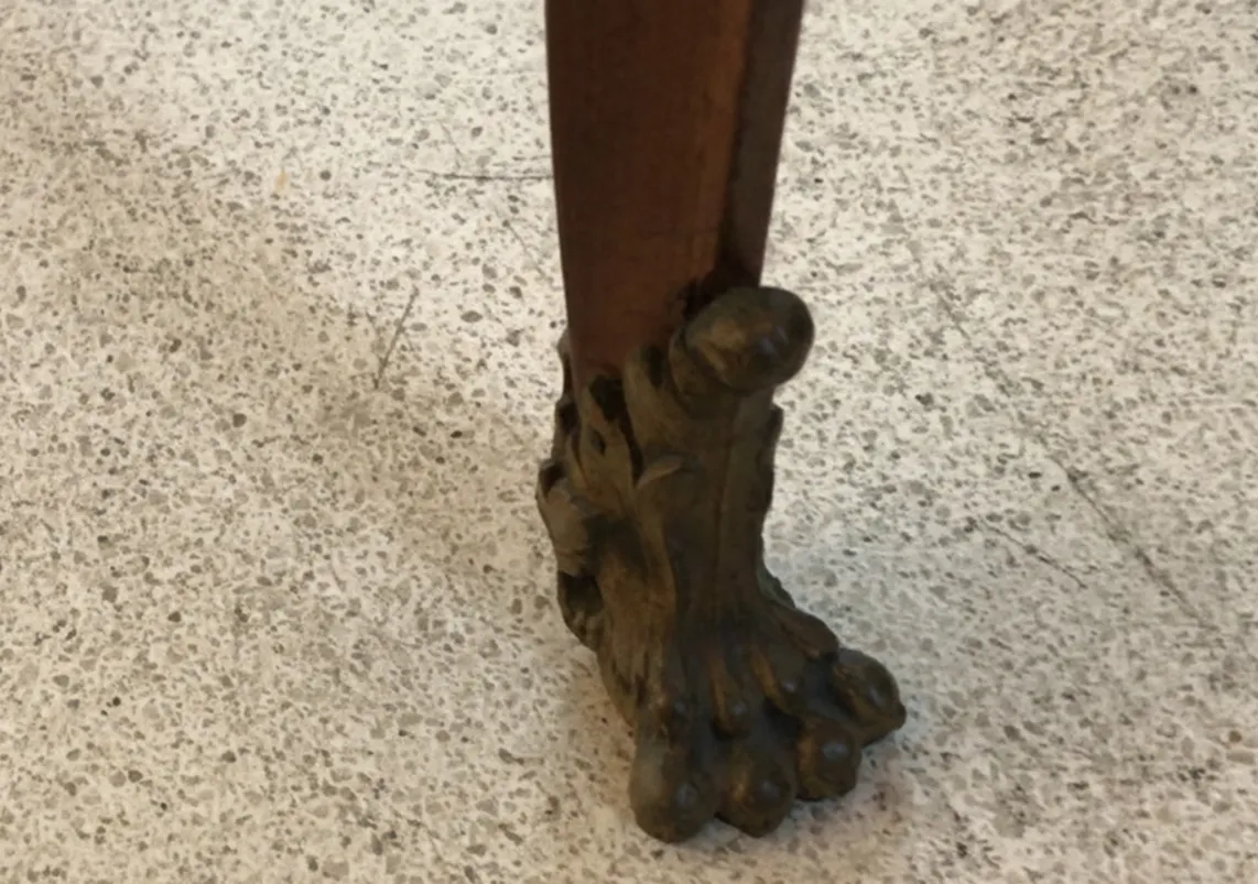 View of the legs of two antique chairs with decorative details