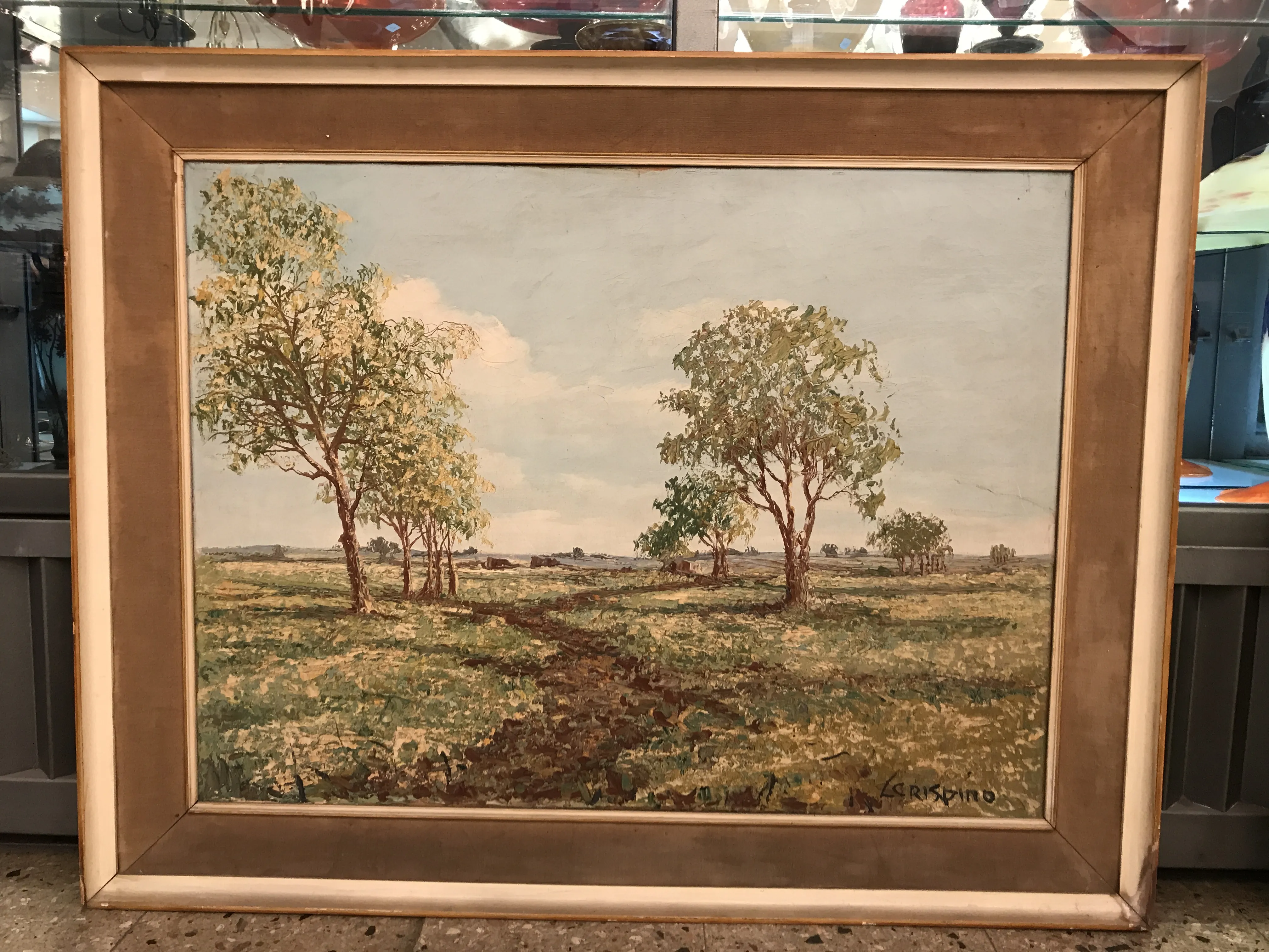 Antico dipinto di paesaggio con alberi e sentiero.