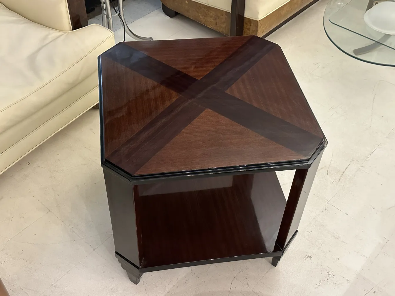 Antique coffee table with art deco design and octagonal shape.