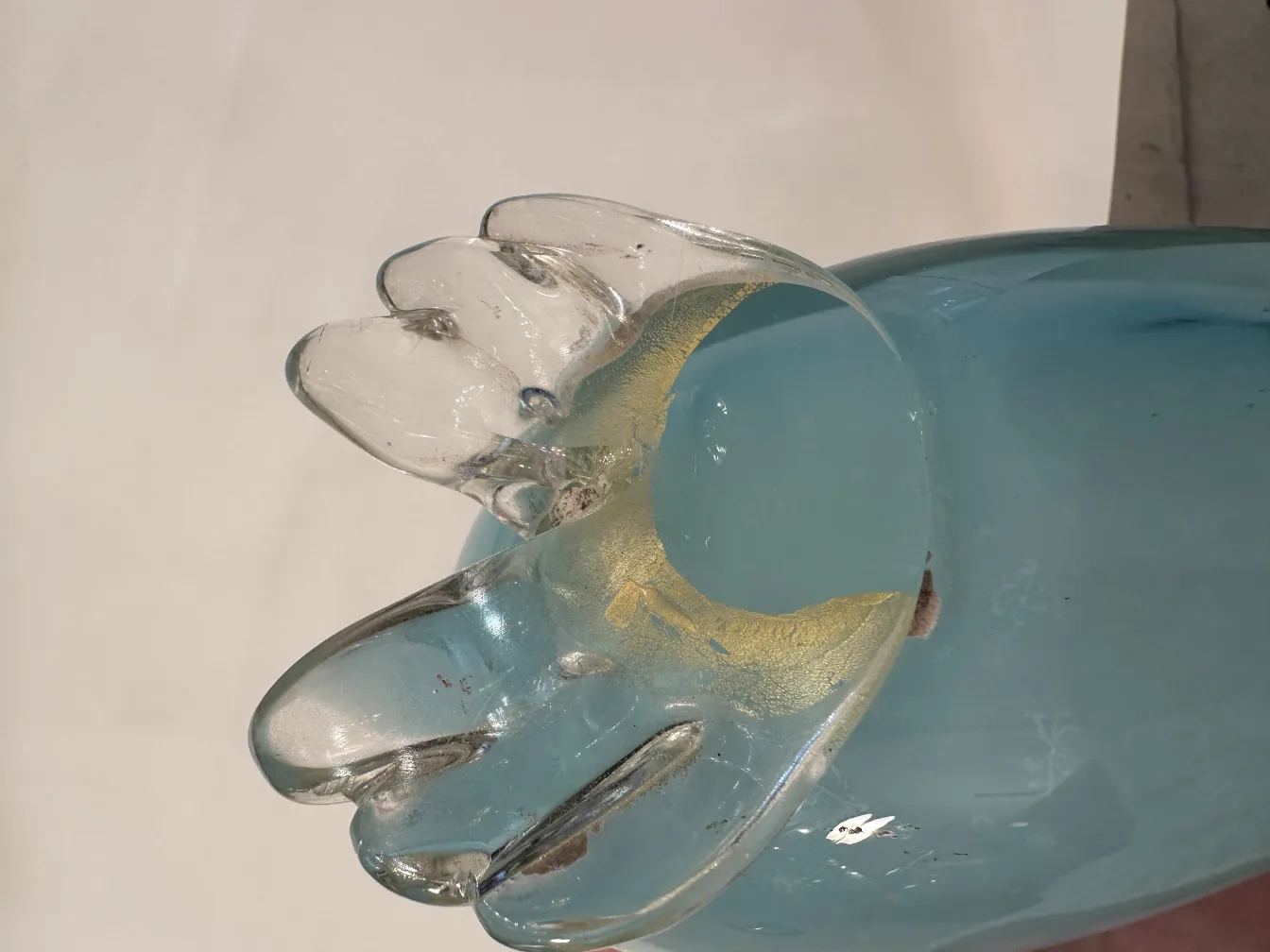 Murano sculpture depicting an animal with soft colors and a stylized shape.