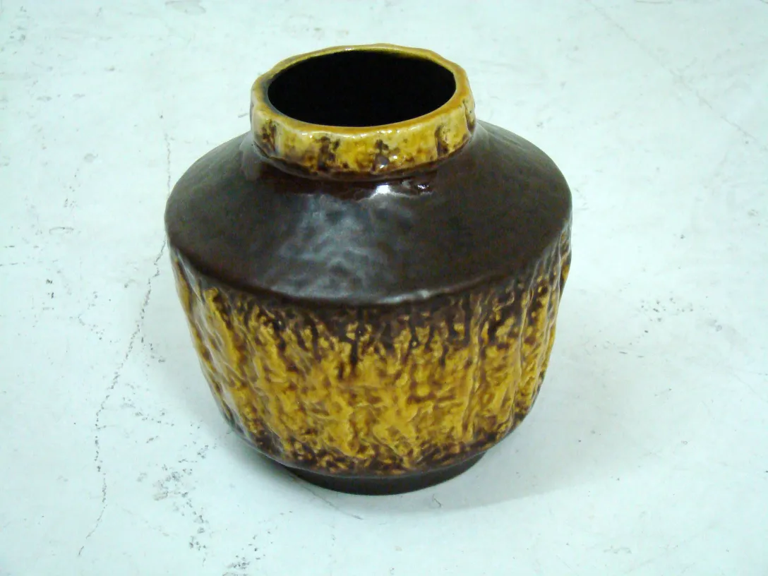 antique ceramic vase with yellow and brown texture