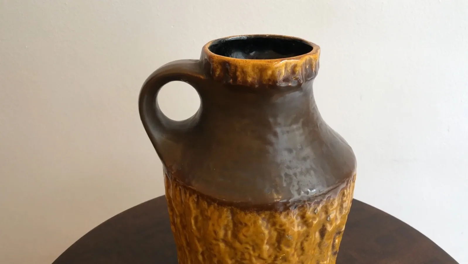 Belle jarre en céramique ancienne avec un design unique et texturé, mettant en valeur un style artisanal dans un décor rustique.