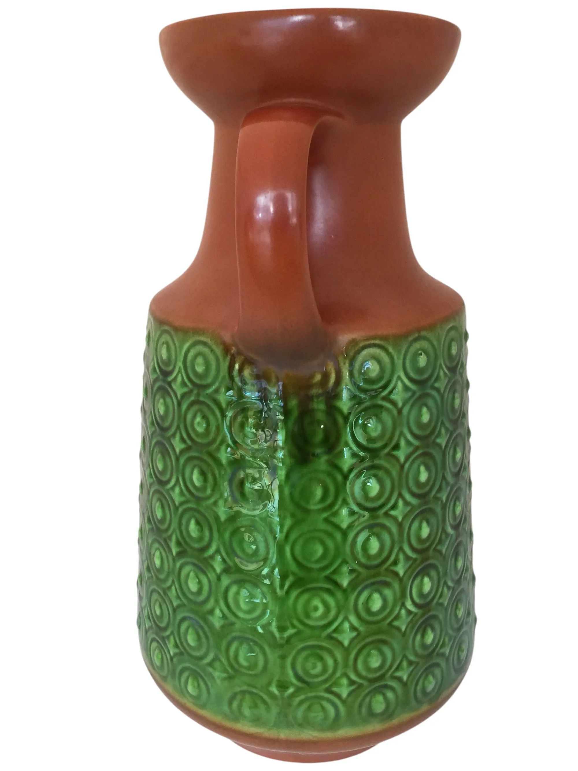 Antique ceramic vase in green and terracotta with textured design.