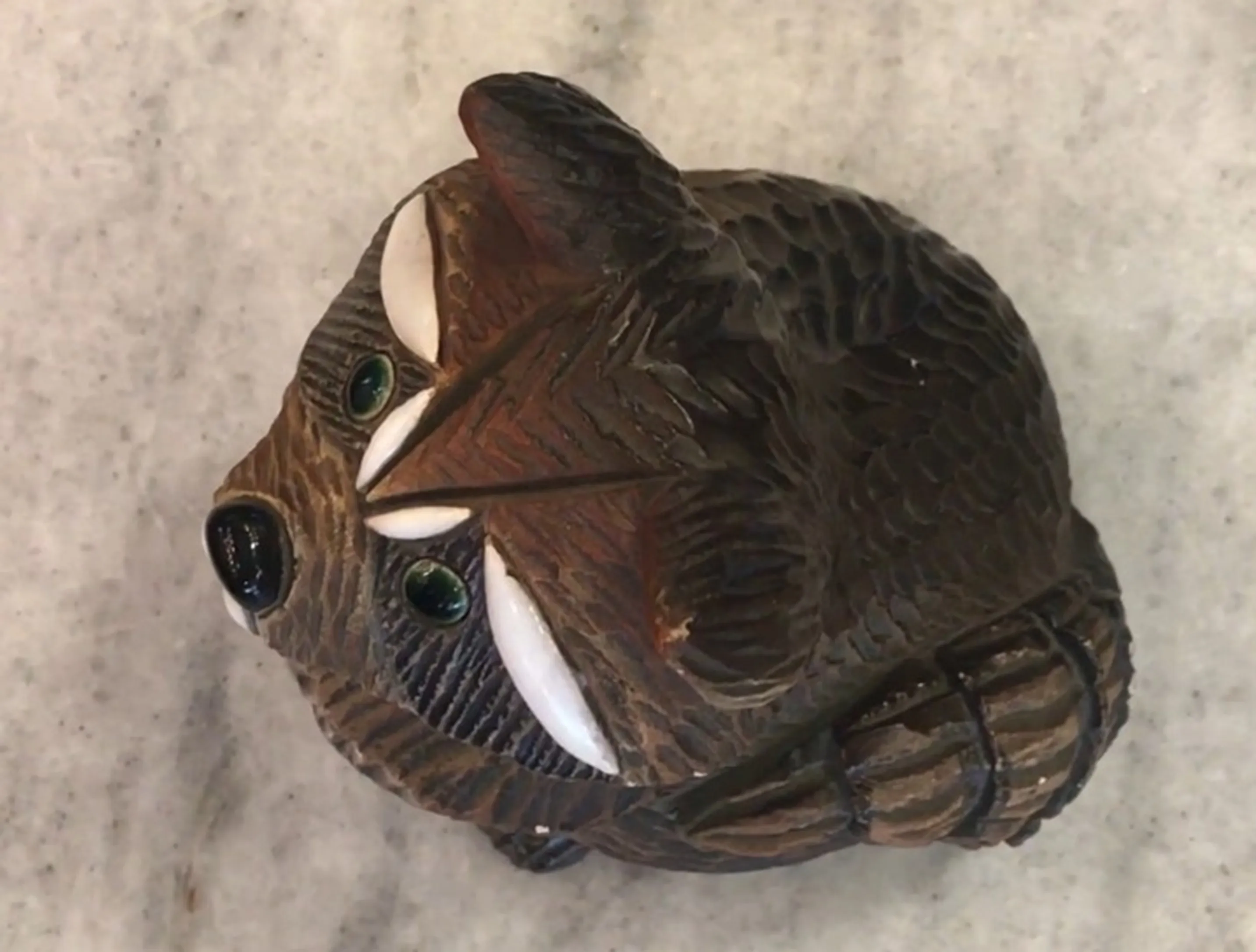Antique ceramic figure with brown details and green eyes, artesania Rinconada style.