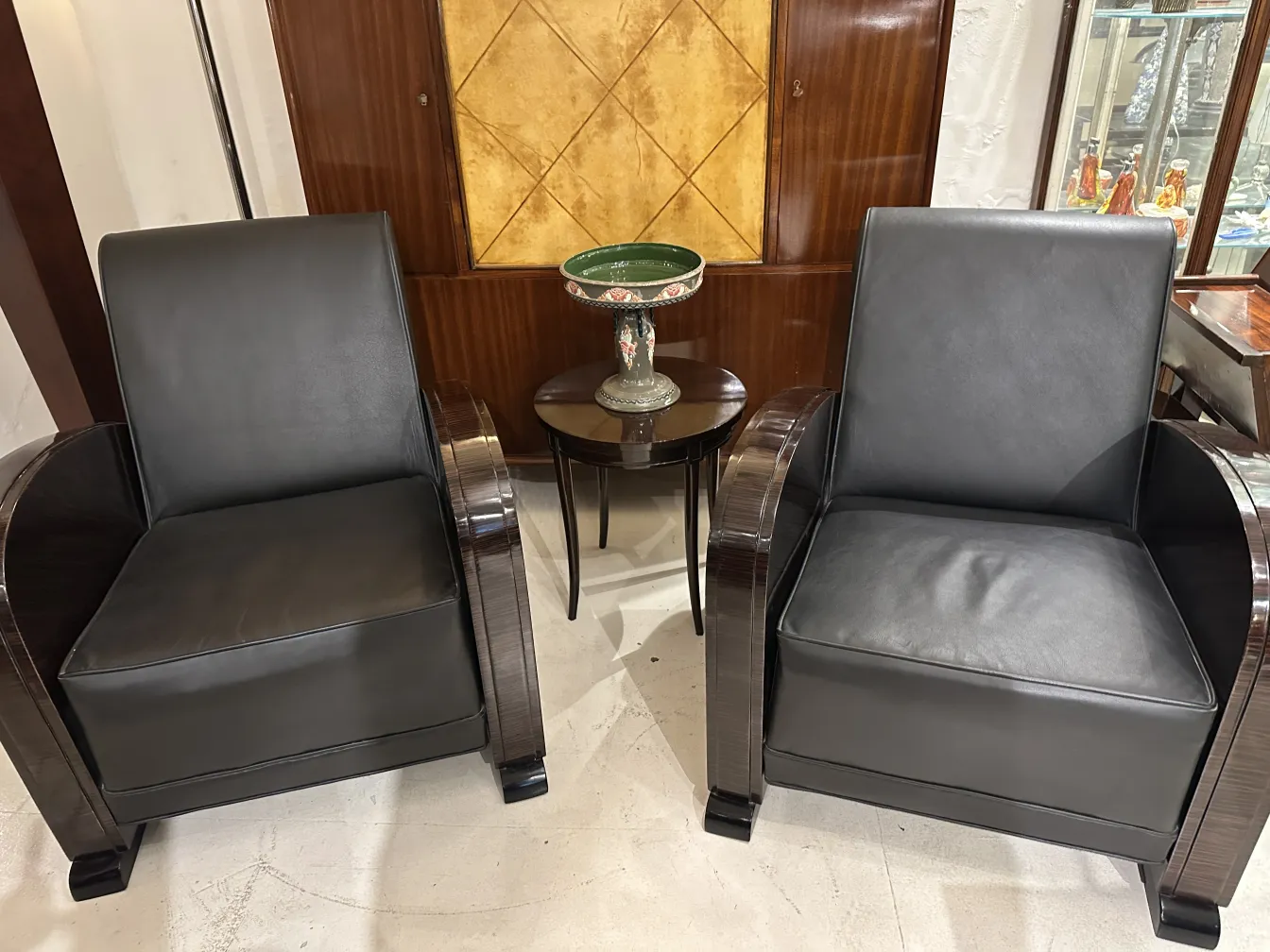 Pair of antique armchairs next to a ceramic piece by Eichwald.
