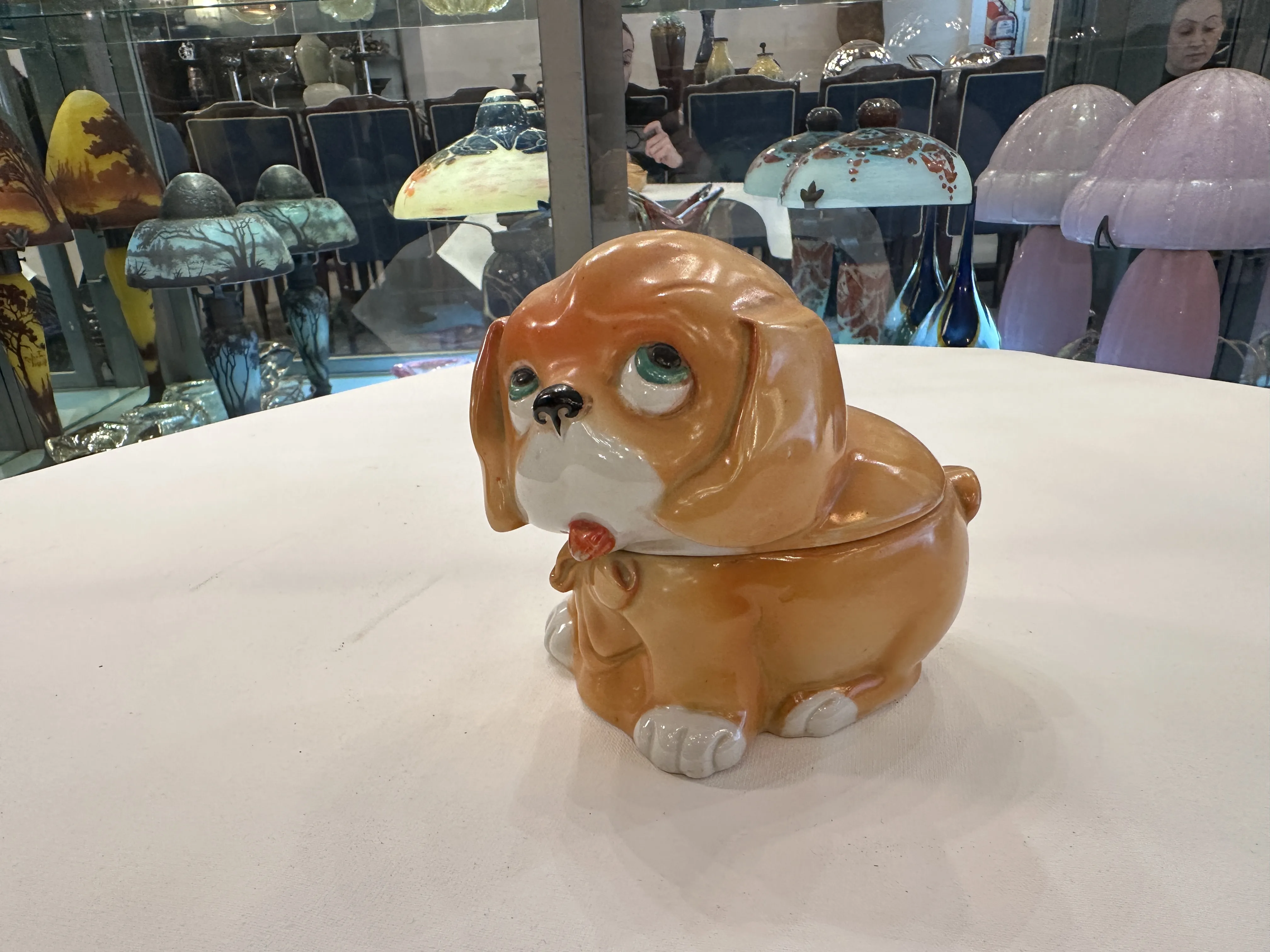 Antique ceramic figurine of a dog with colorful details, decorative.