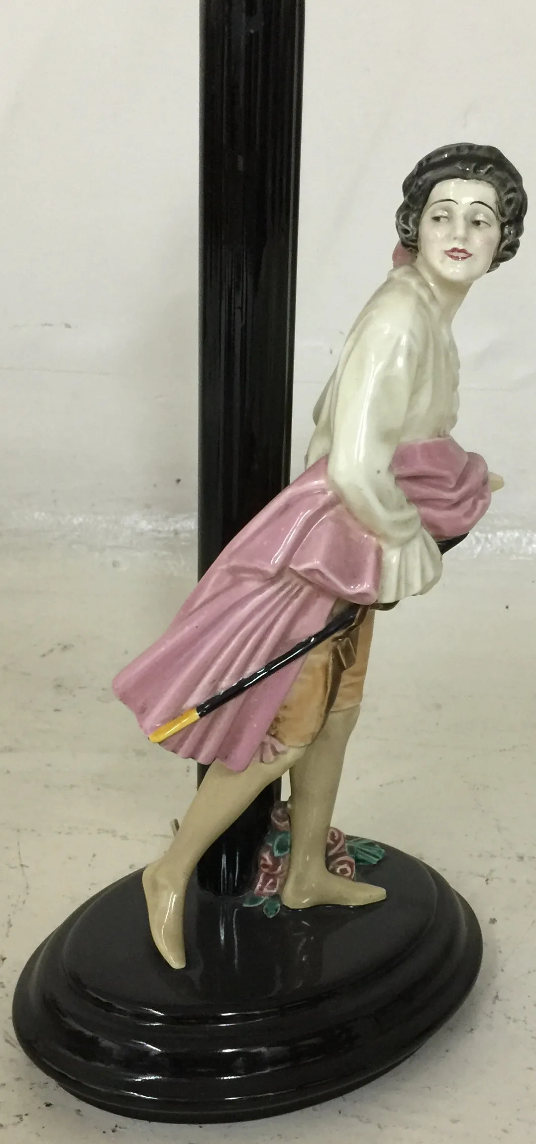 Antique table lamp with woman figure in light and pink colors on black base