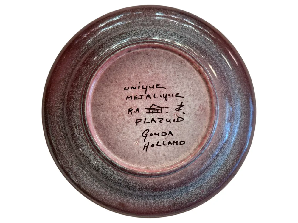 Antique ceramic with purple tones, signature visible.