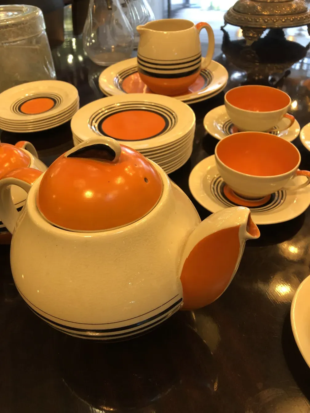 Antique tea set by Susie Cooper with colorful plates and cups