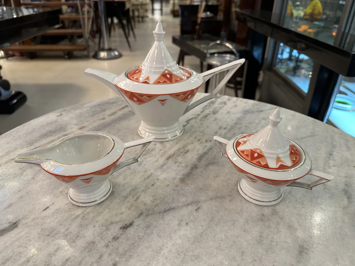 Antique tea set Volkstedt with colorful patterns on the table.