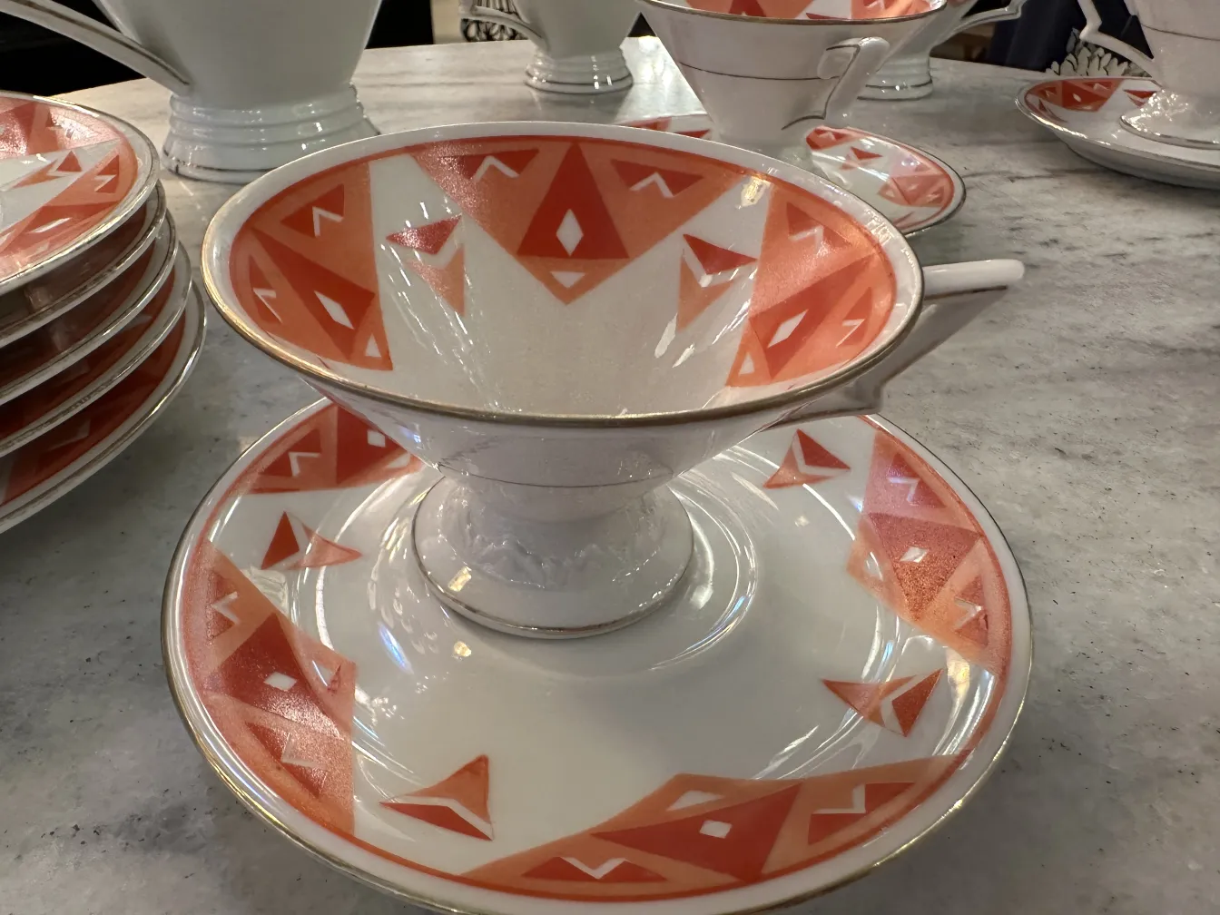 Antique tea set Volkstedt with colorful patterns on the table.