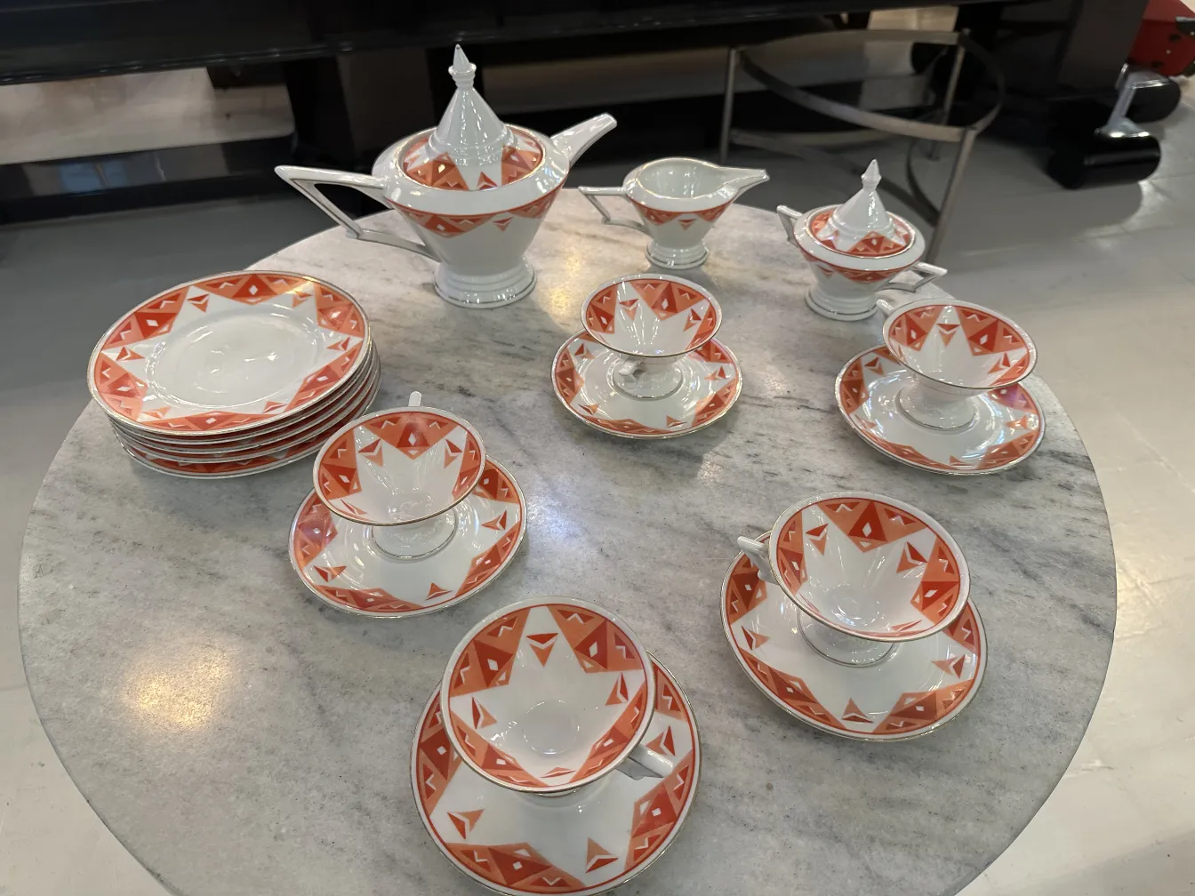 Antique tea set Volkstedt with colorful patterns on the table.