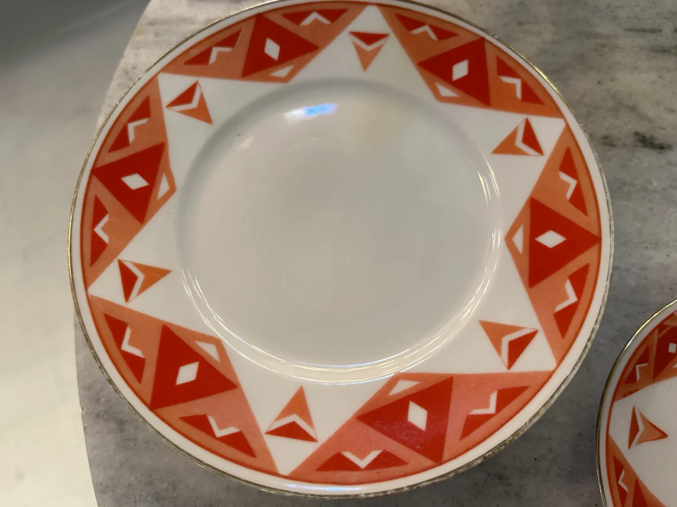 Antique tea set Volkstedt with colorful patterns on the table.