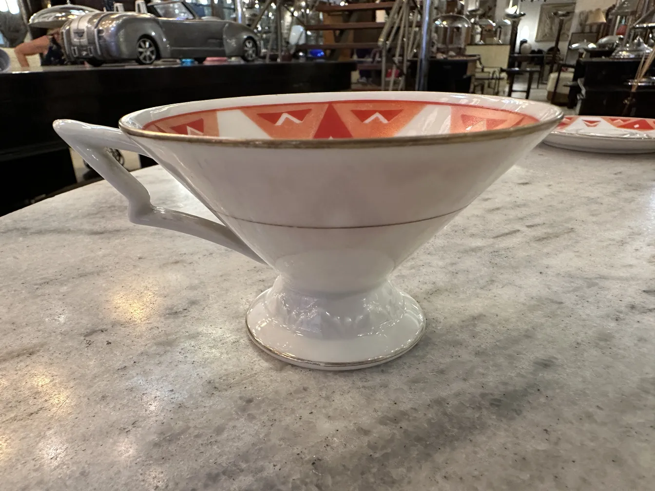 Antique tea set Volkstedt with colorful patterns on the table.