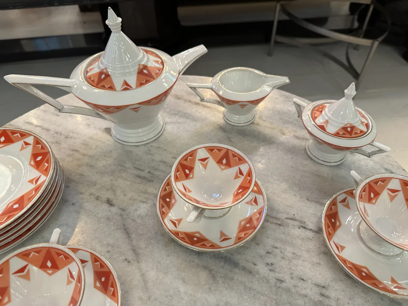 Antique tea set Volkstedt with colorful patterns on the table.