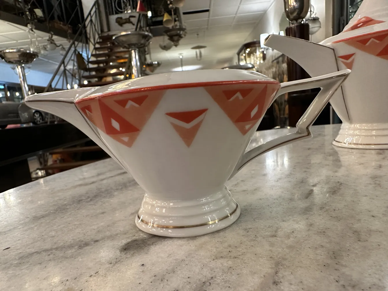 Antique tea set Volkstedt with colorful patterns on the table.