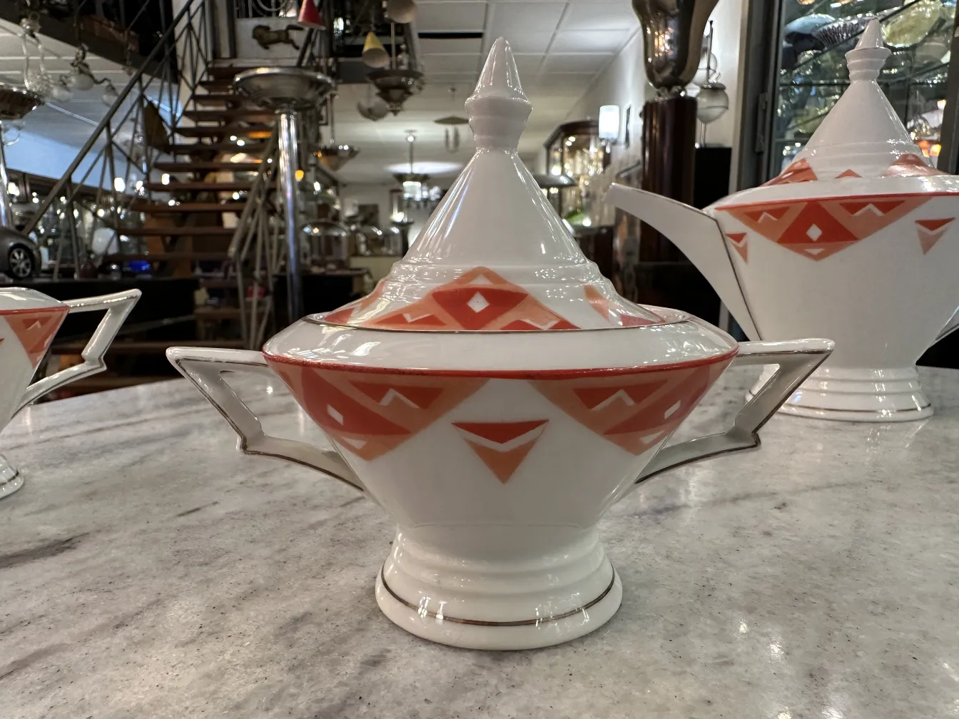 Antique tea set Volkstedt with colorful patterns on the table.
