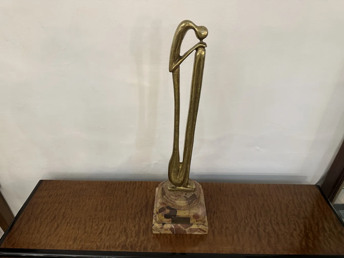Scultura antica con forma elegante e base decorativa.