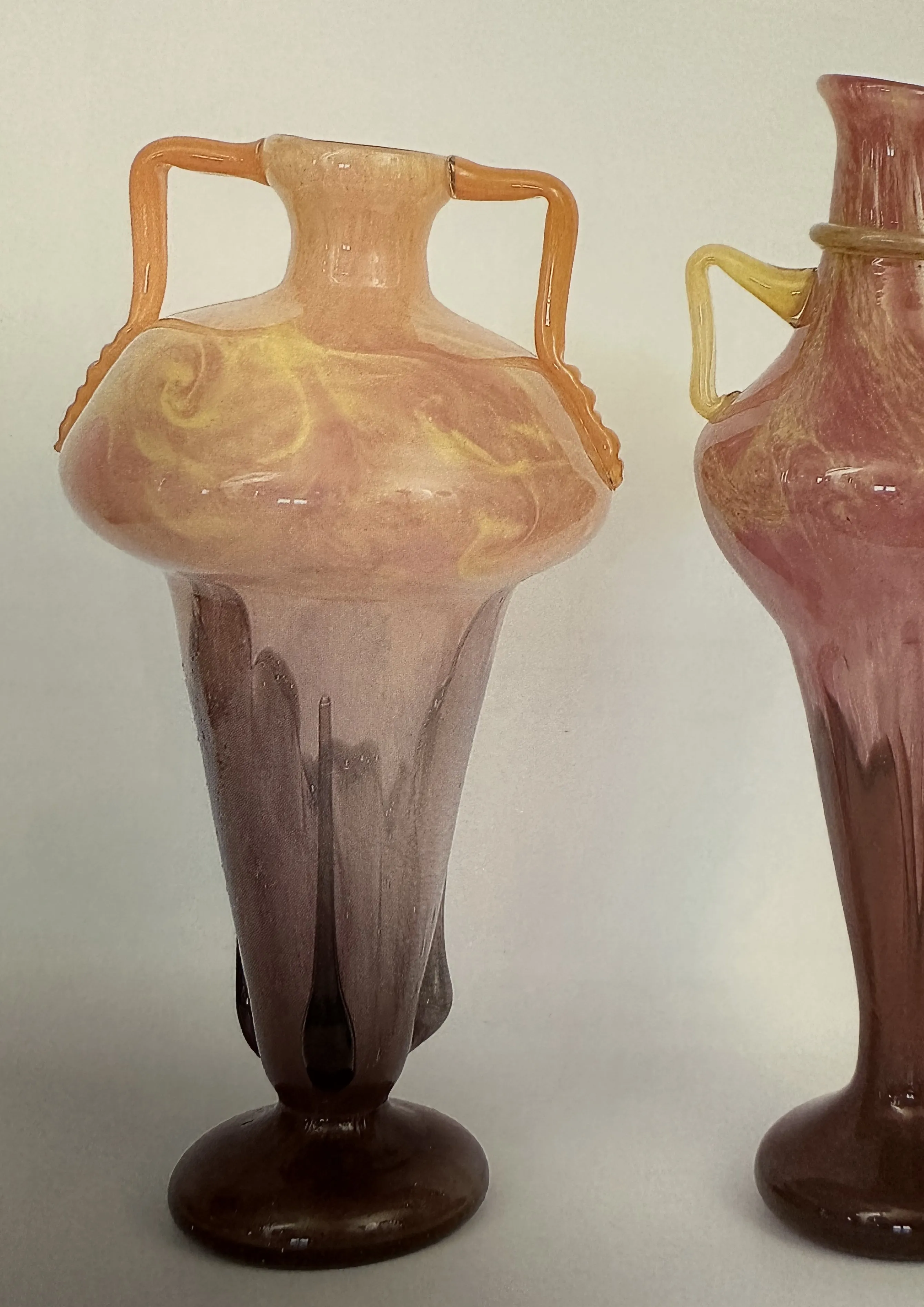 Antique glass featuring pastel patterns and decorative handles.
