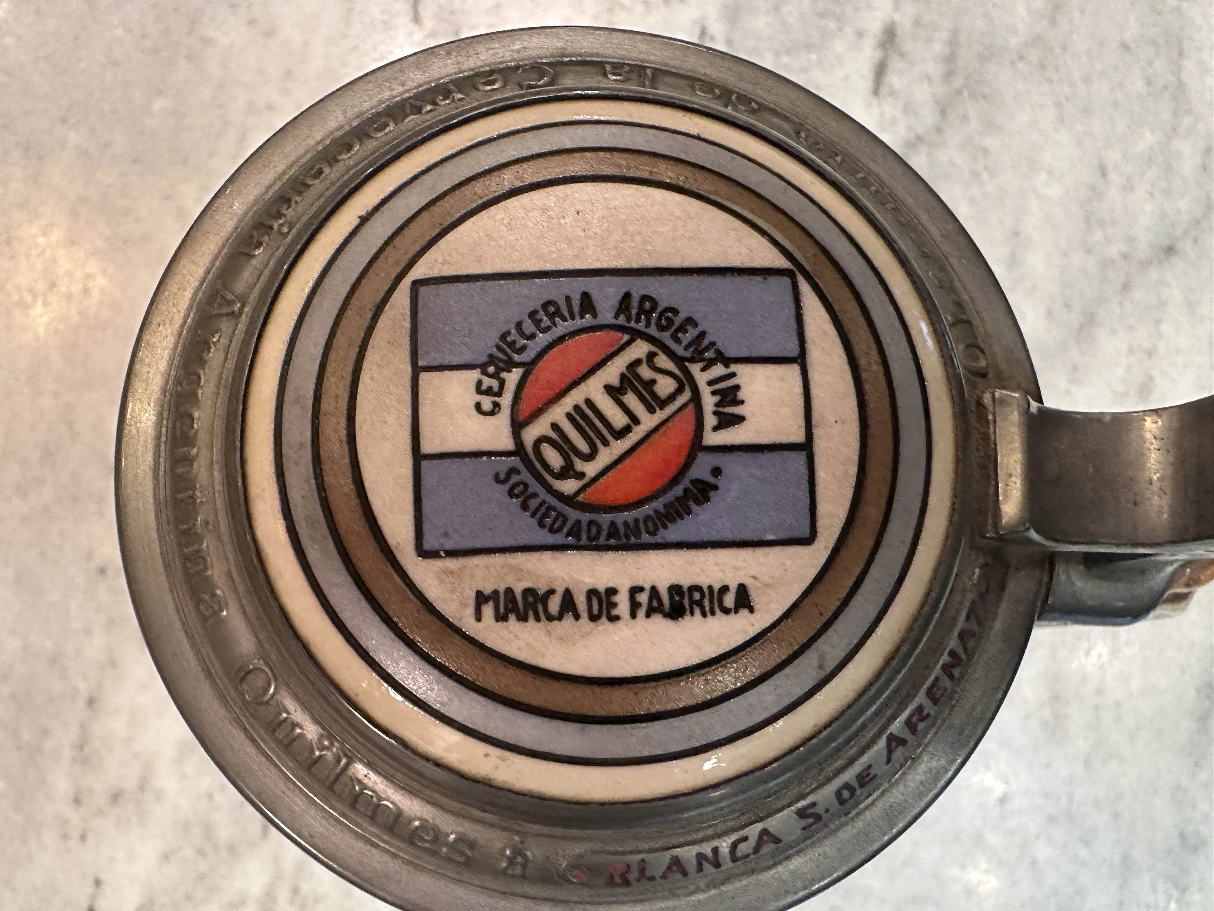 Antique ceramic mug featuring Quilmes design