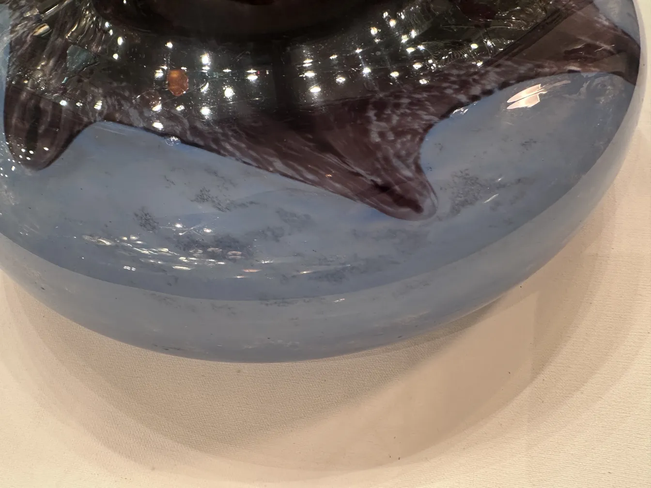 Top view of an antique signed glass Degué with wavy edges