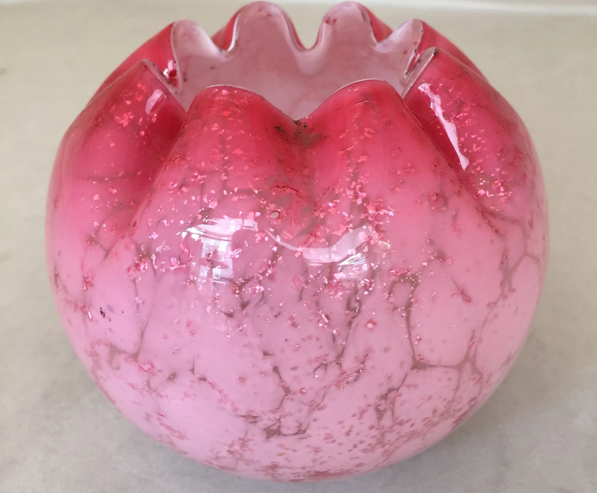 antique round glass piece featuring pink details