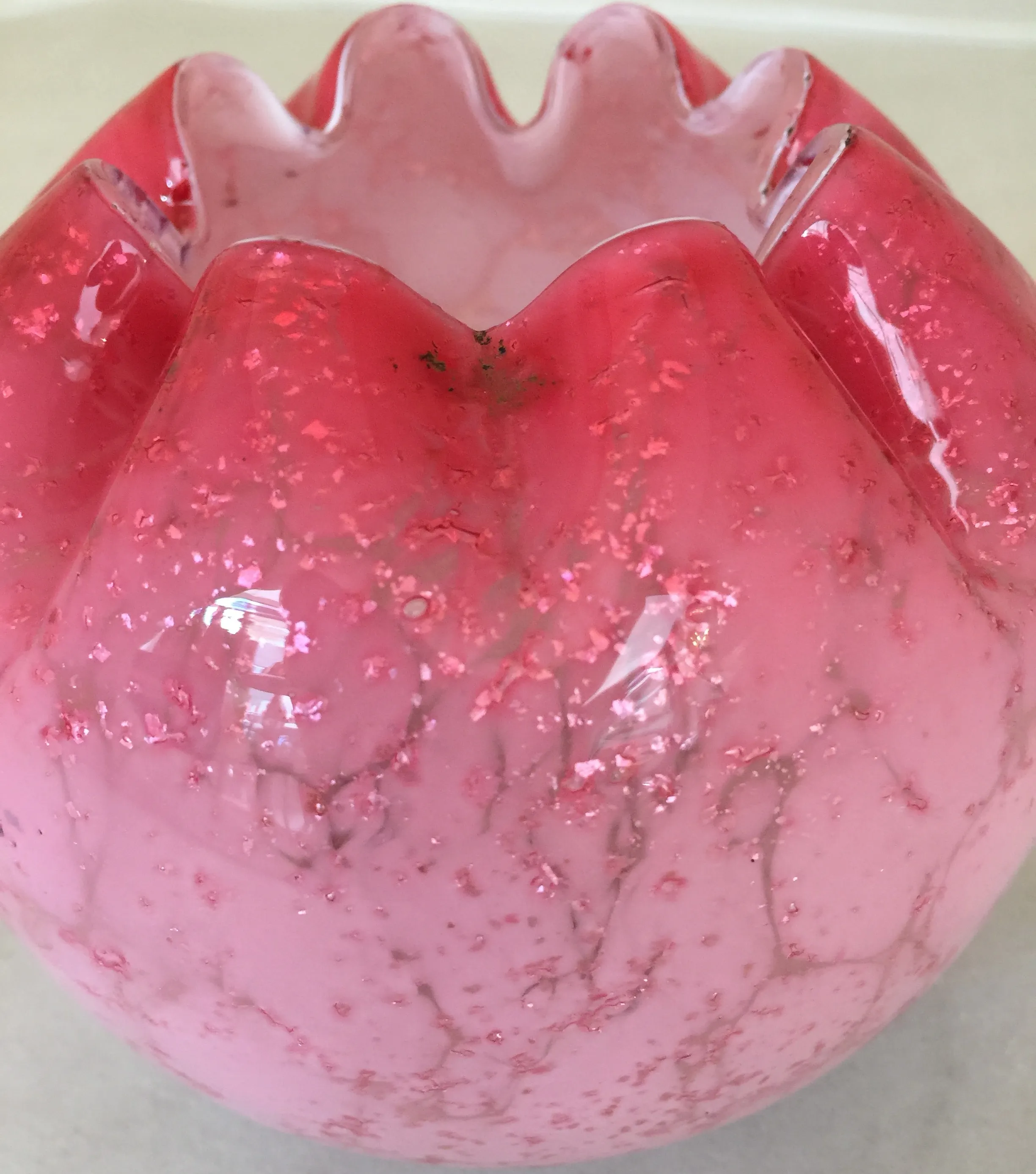 antique glass piece in pink with decorative details