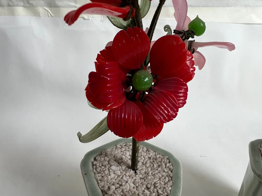 Bonsai ancien avec des fleurs rouges dans un pot
