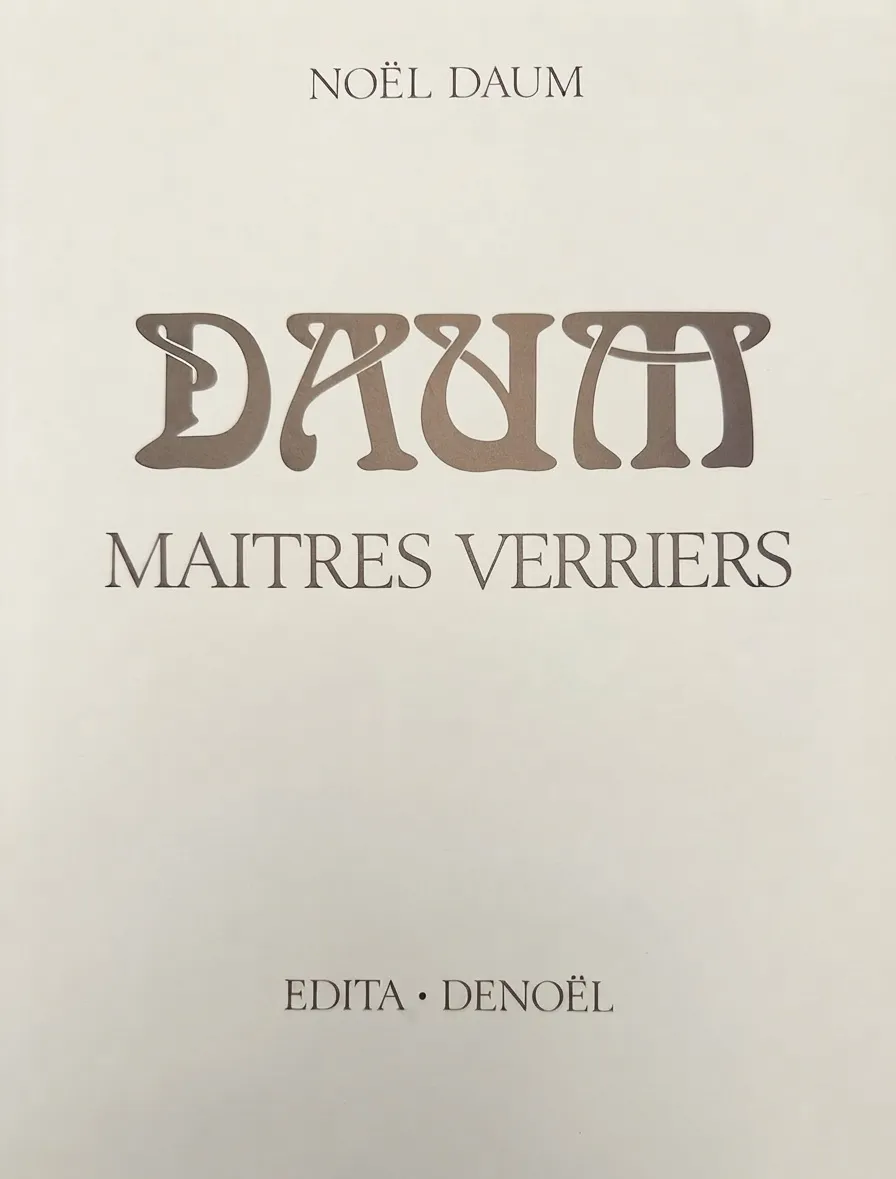 Signed glass from Daum Nancy, antique with elegant detail on a light background.