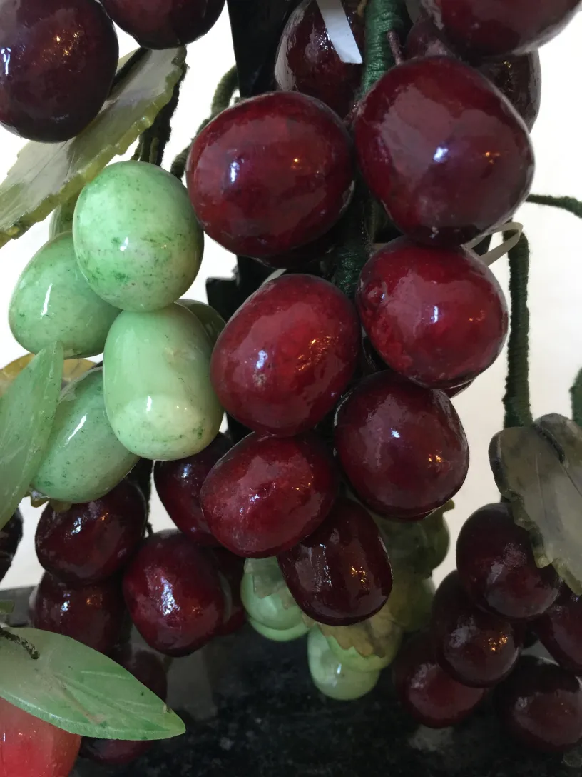 Antique bonsai featuring red and green fruits