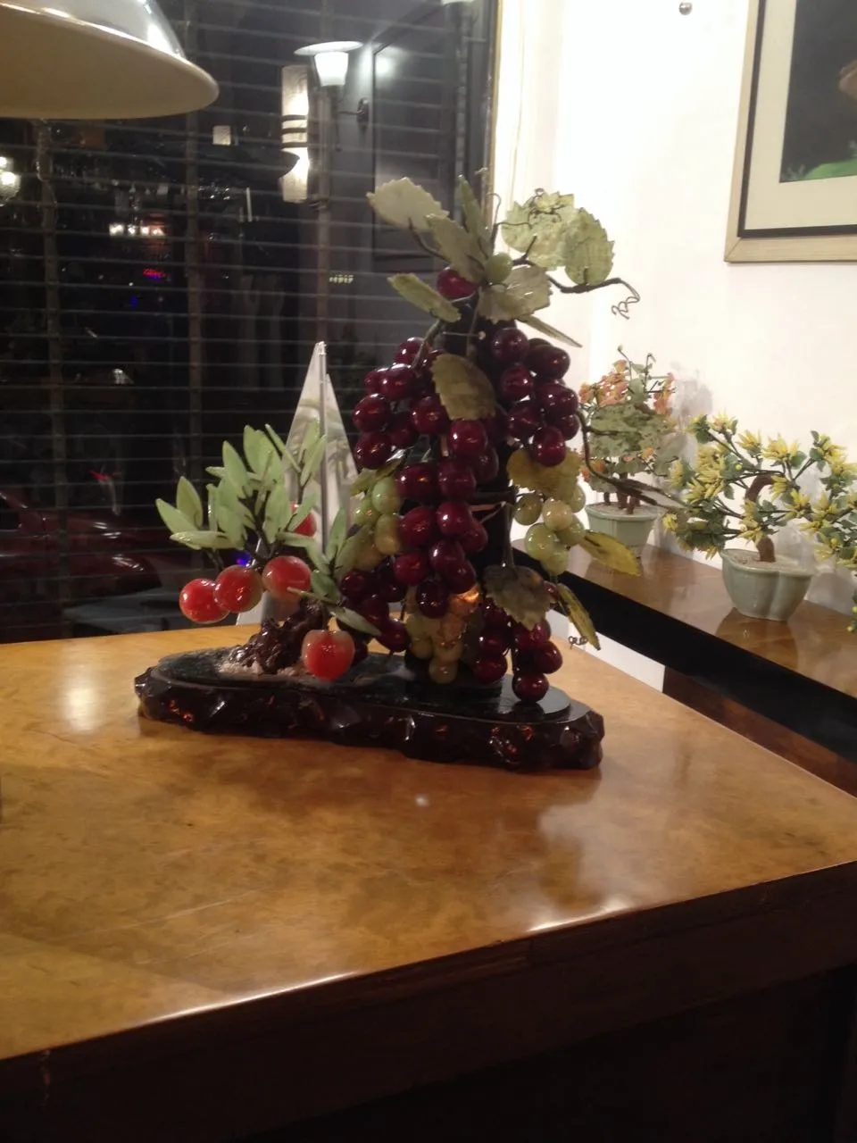 Antique decorative bonsai with green leaves and fruits.
