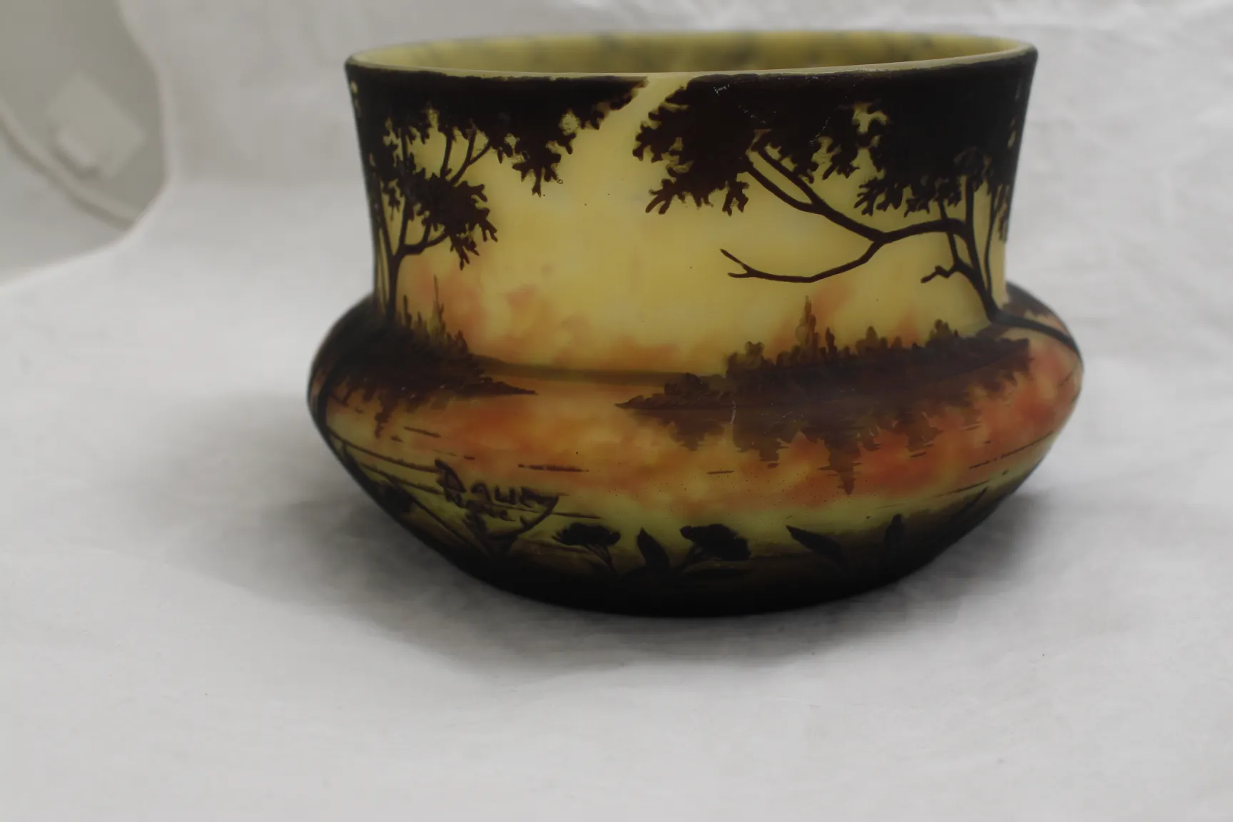 Antique signed glass by Daum Nancy featuring a decorative landscape of nature.