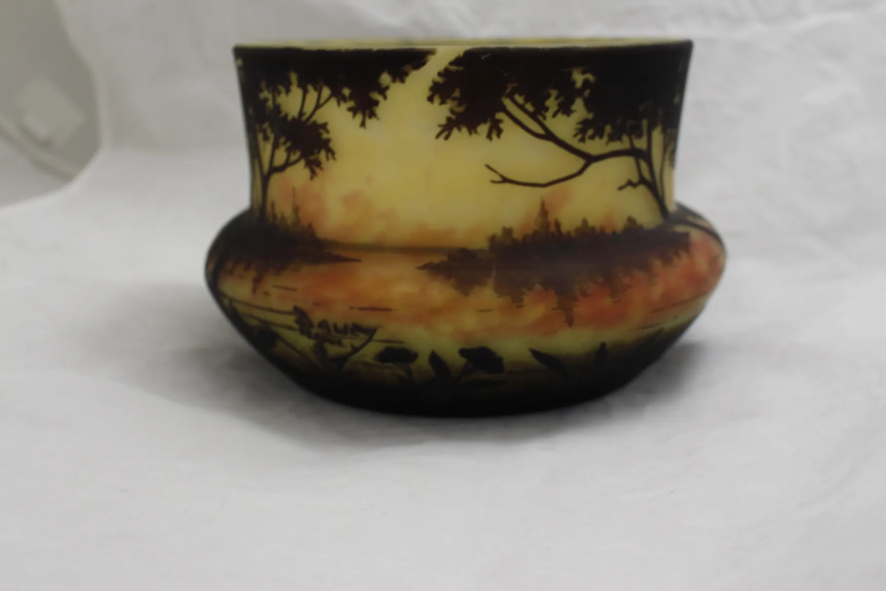 Antique signed glass by Daum Nancy featuring a decorative landscape of nature.