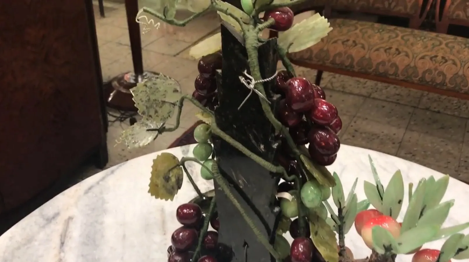 Antique decorative bonsai with red and green fruits.