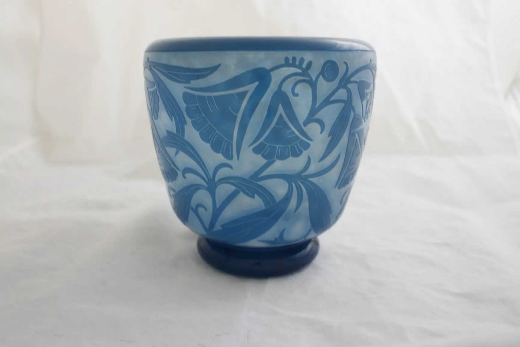 Antique blue glass by Daum Nancy with floral relief design.