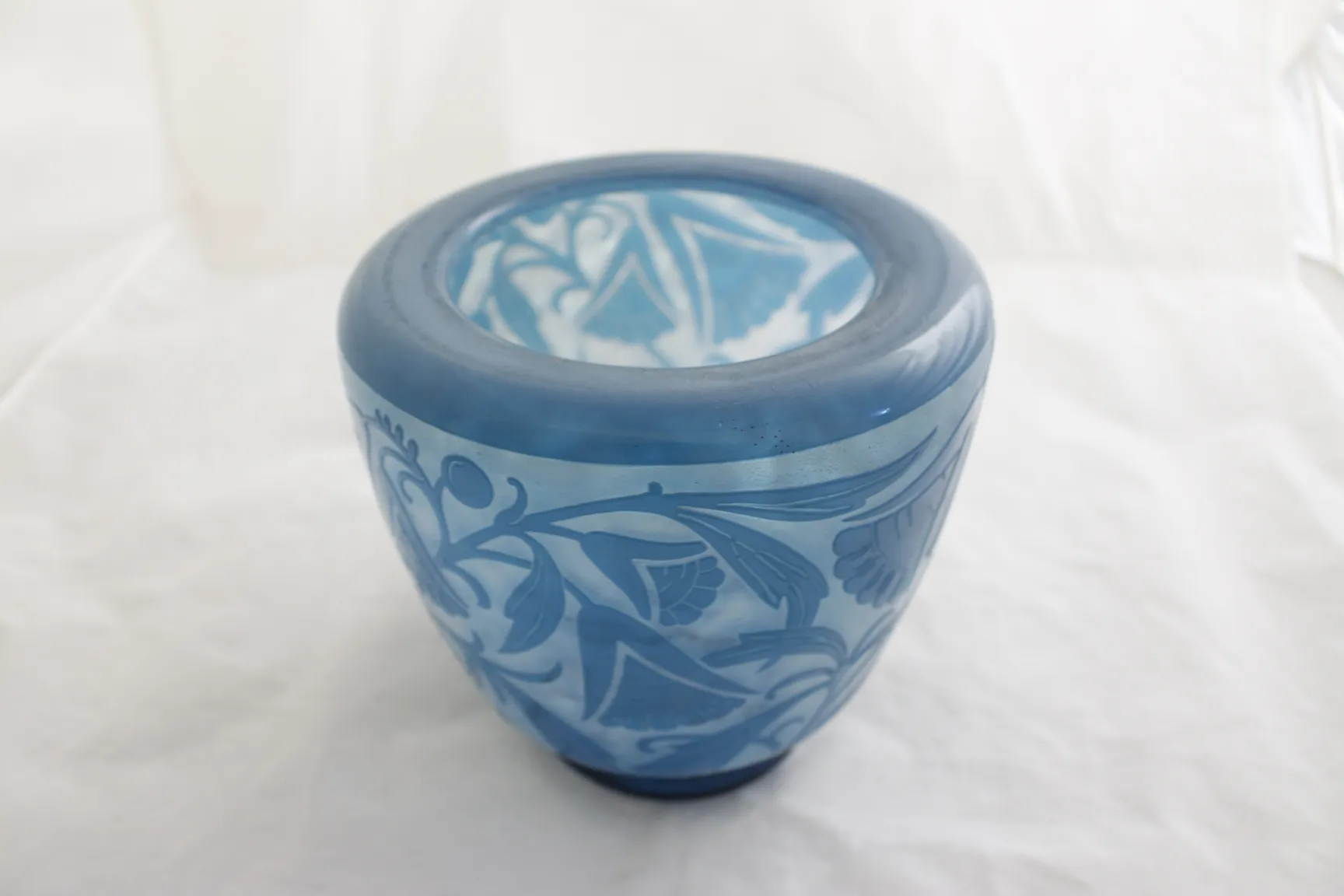 Antique blue glass by Daum Nancy with floral relief design.