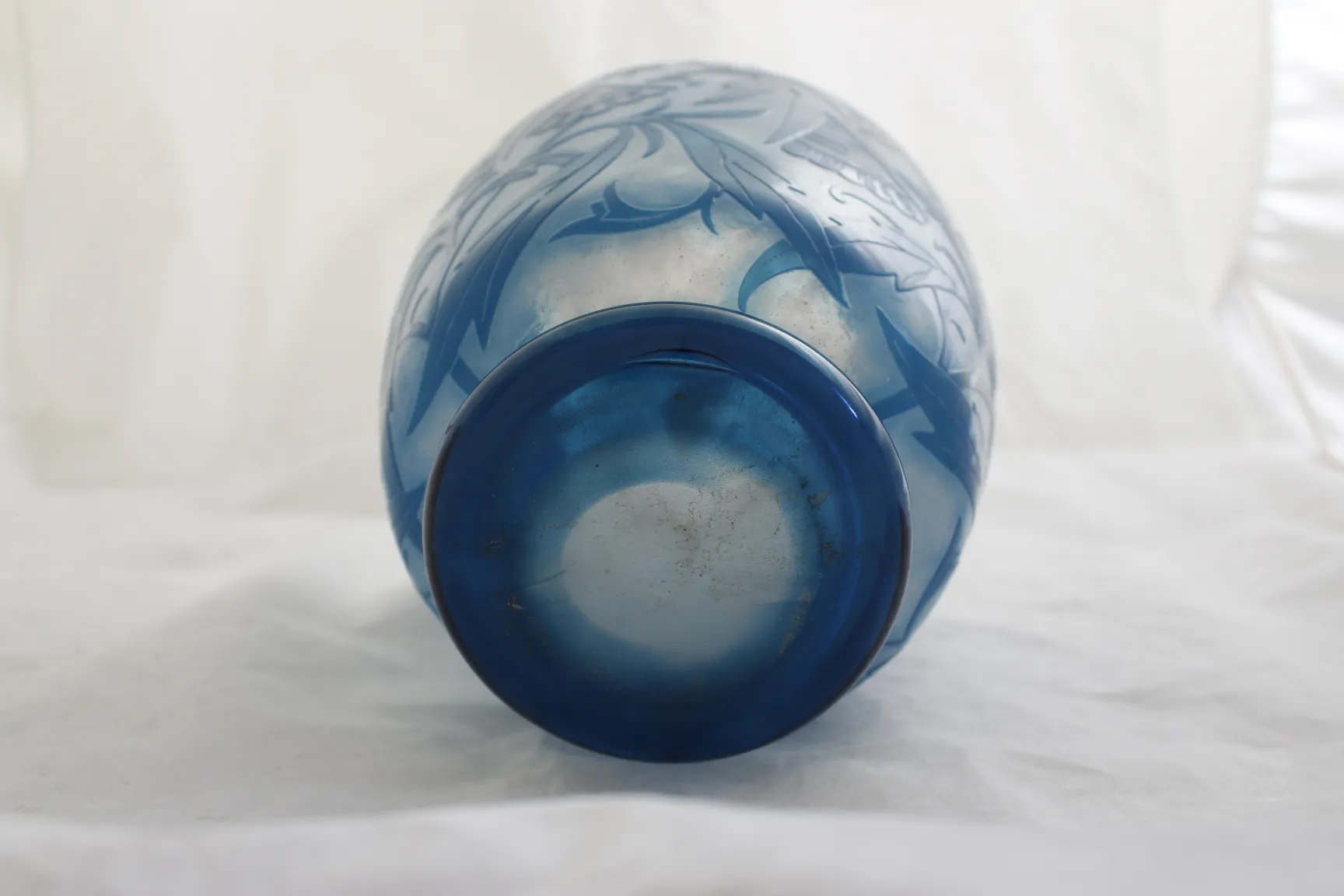 Antique blue glass by Daum Nancy with floral relief design.