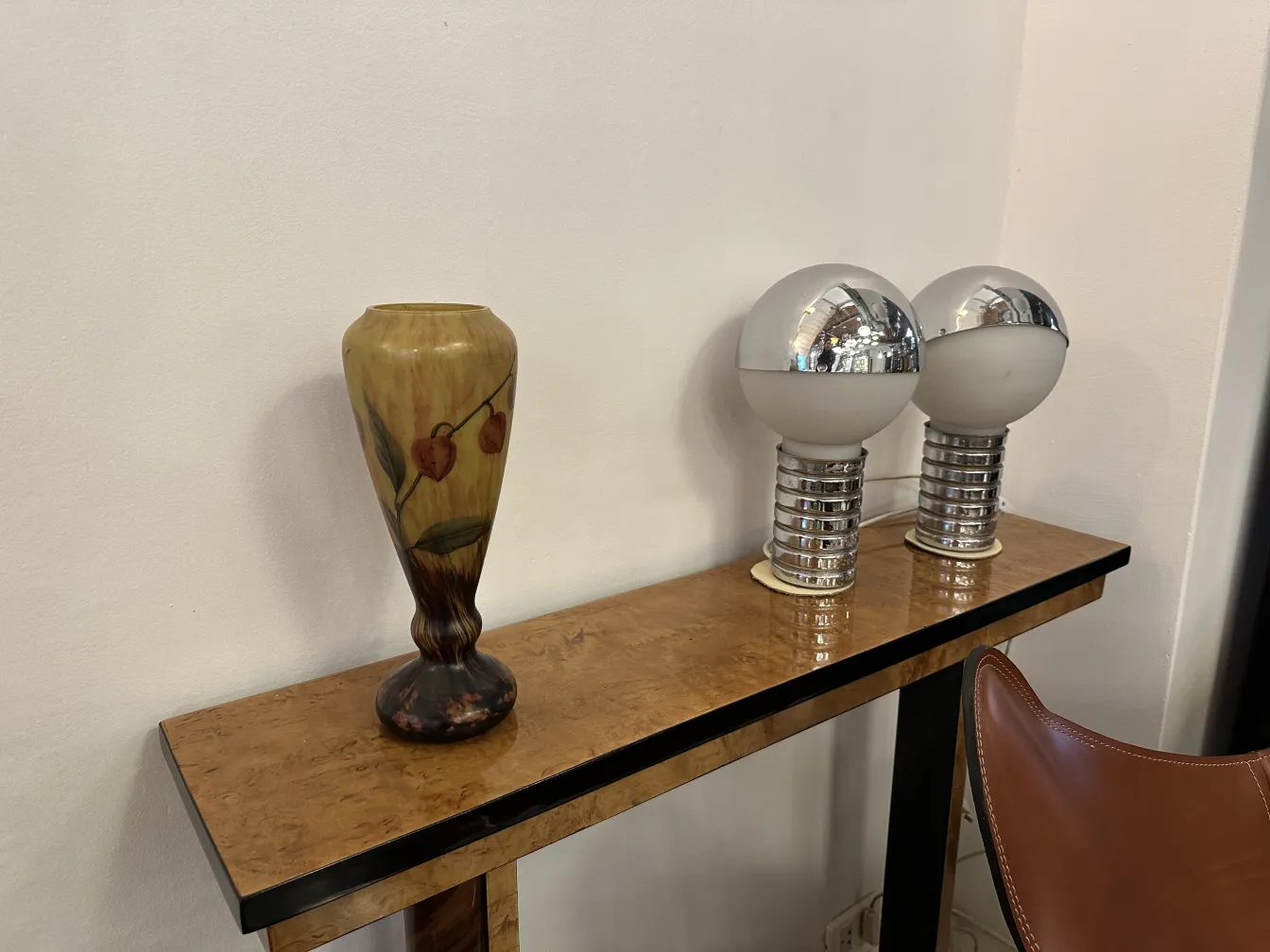 Antique vase with leaf and fruit design on the table.