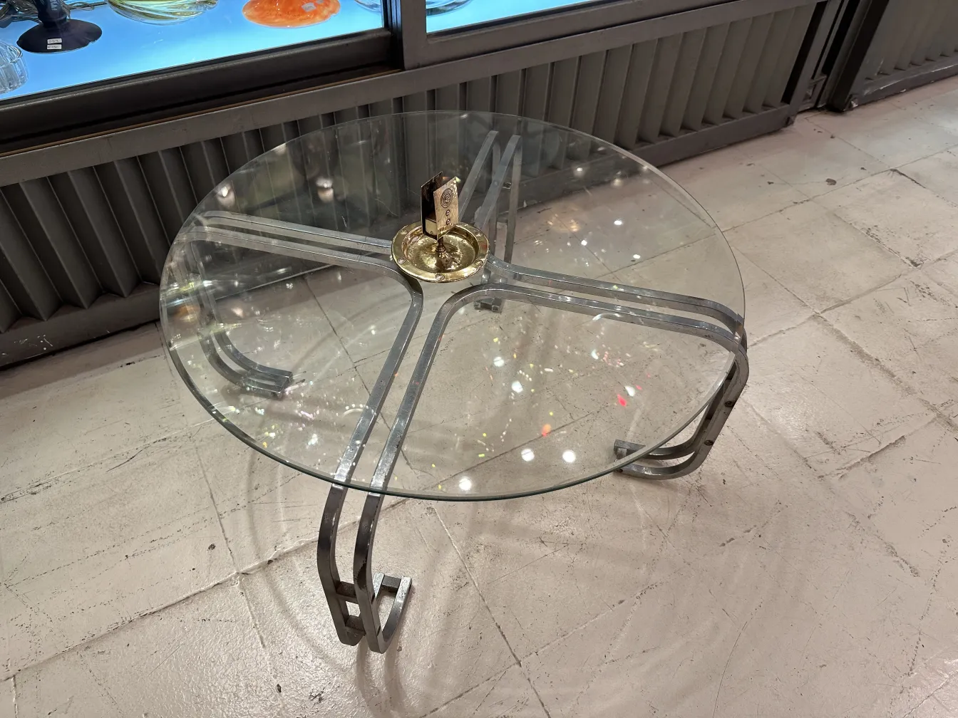 Antique WMF ashtray with decorative design and circular shape.