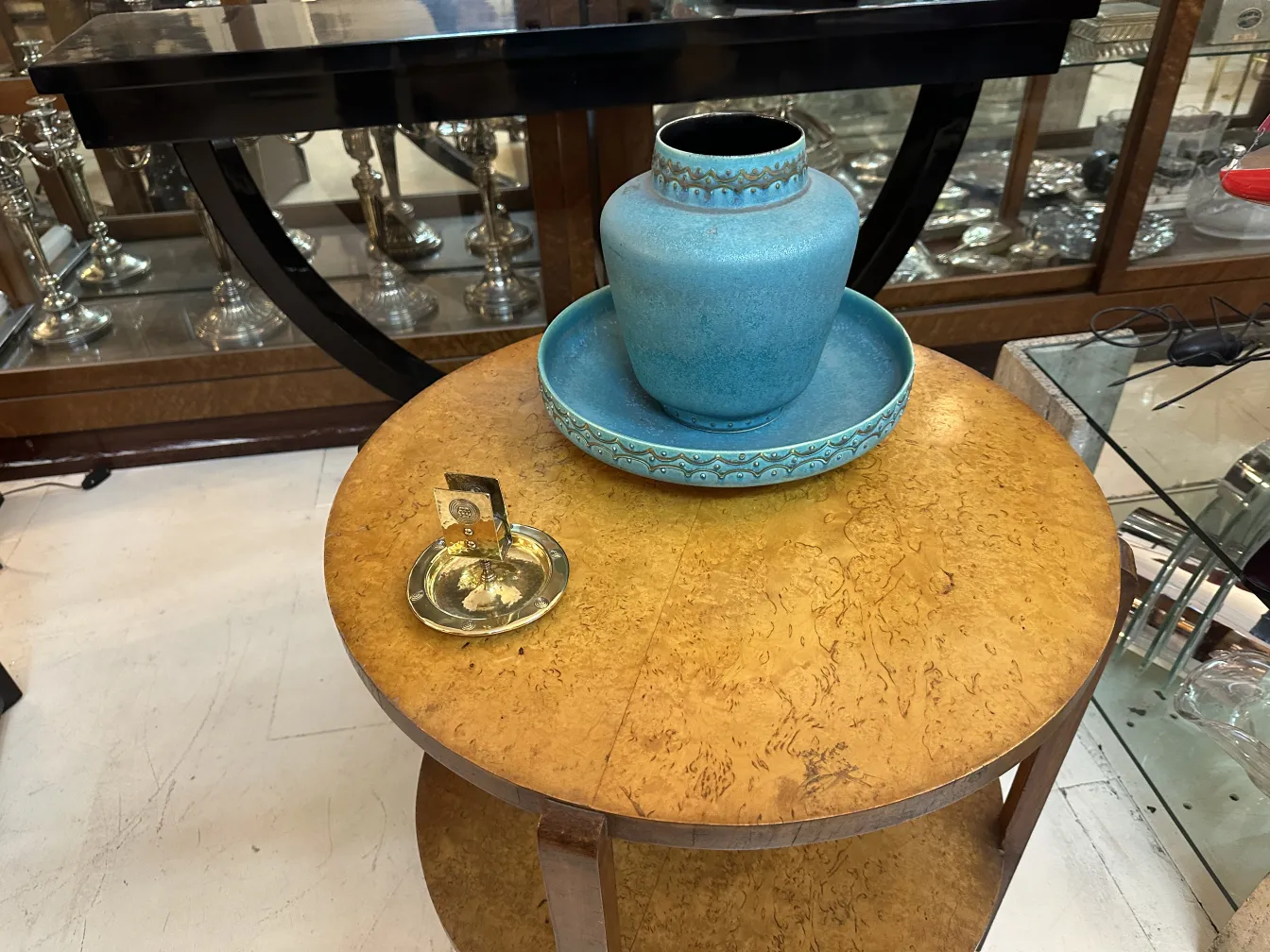 Antique WMF ashtray with decorative design and circular shape.