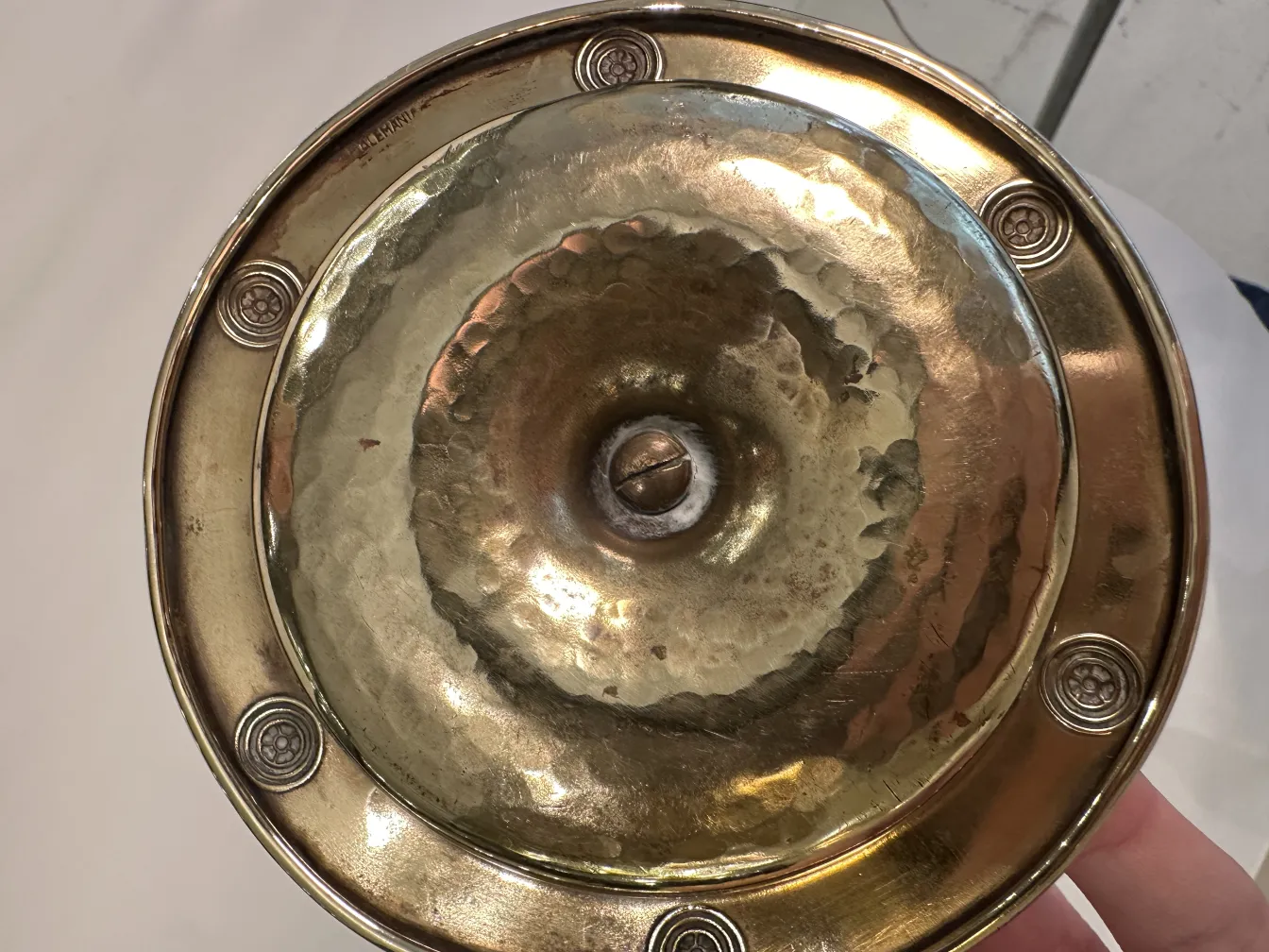 Antique WMF ashtray with decorative design and circular shape.